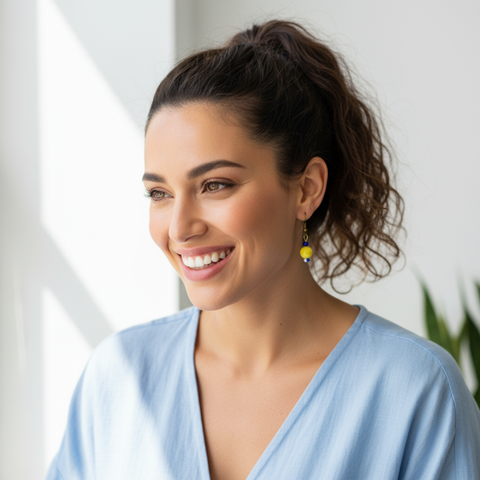 Model wearing yellow, blue, and white beaded earrings