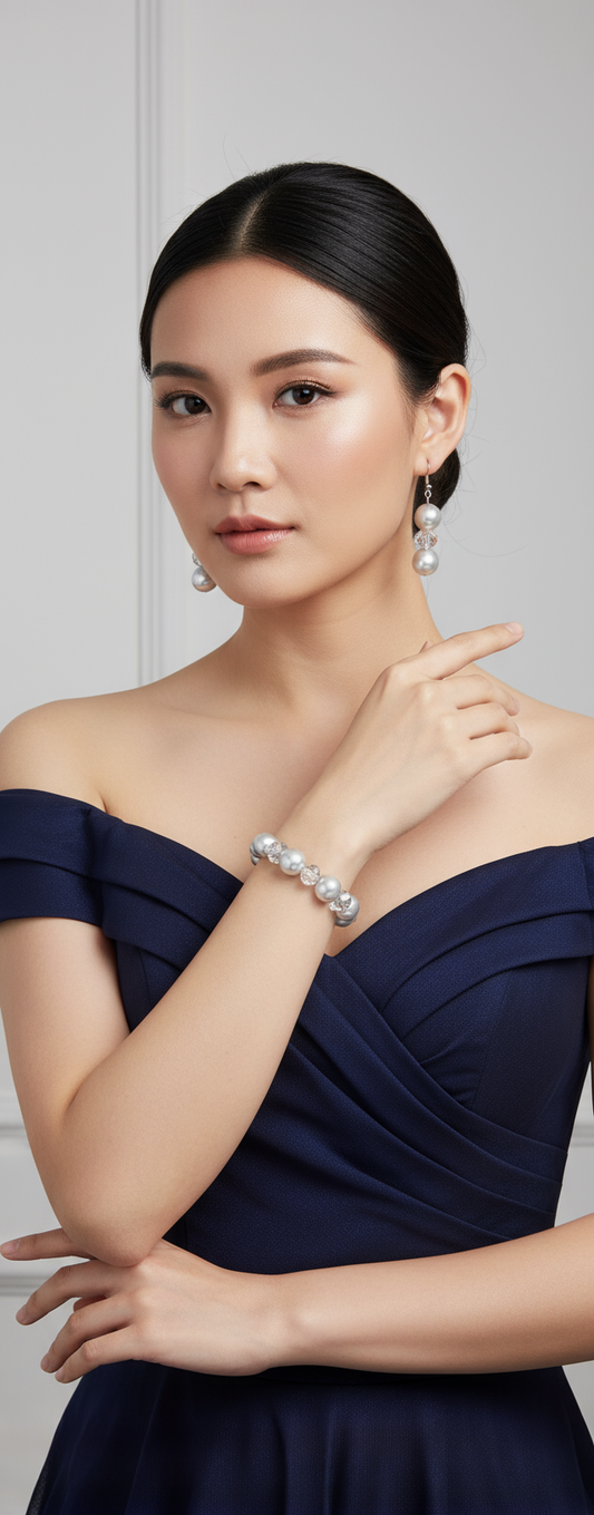 Asian model wearing silver pearl and crystal jewelry set in elegant dress
