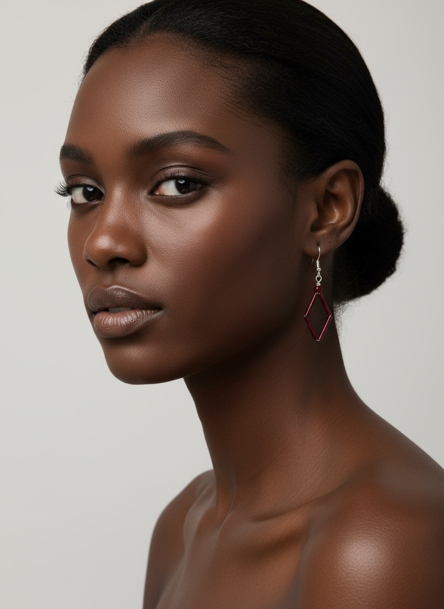 Black model wearing burgundy diamond-shaped earrings