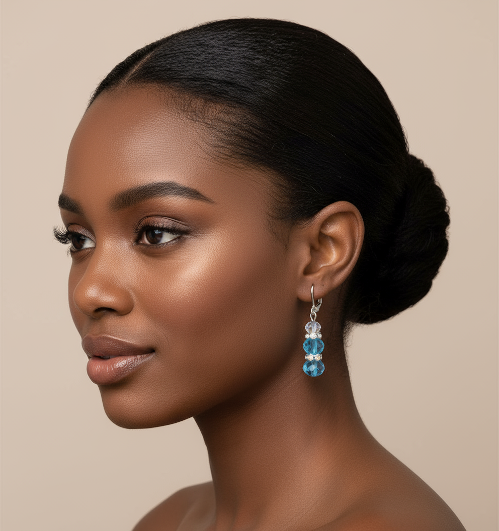 Black woman wearing blue crystal earrings