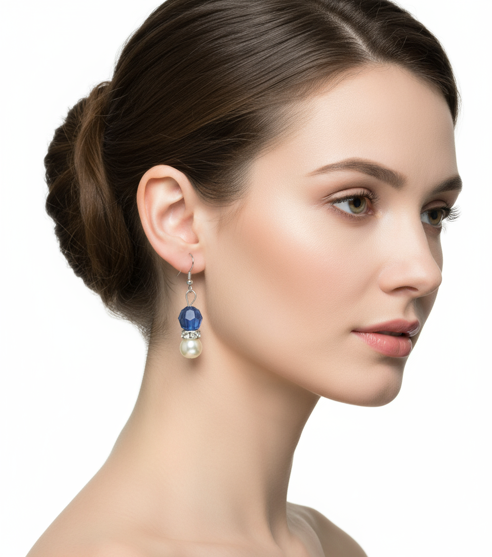Model wearing blue crystal and white pearl drop earrings
