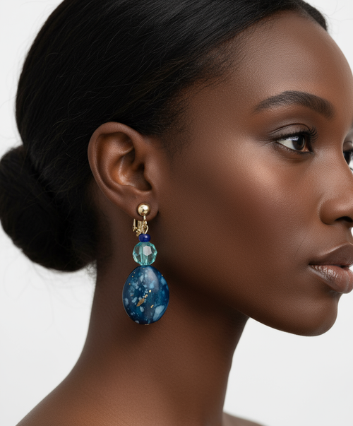 Model wearing blue green clip-on earrings